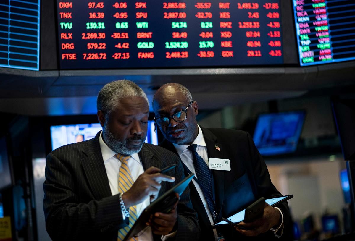 Traders work after the closing bell at the New York Stock Exchange (NYSE) on August 12, 2019 at Wall Street in New York City. - Wall Street stocks finished a bruising session sharply lower as worries about slowing growth and the protracted US-China trade war hit banking shares and the broader market. (Photo by Johannes EISELE / AFP)