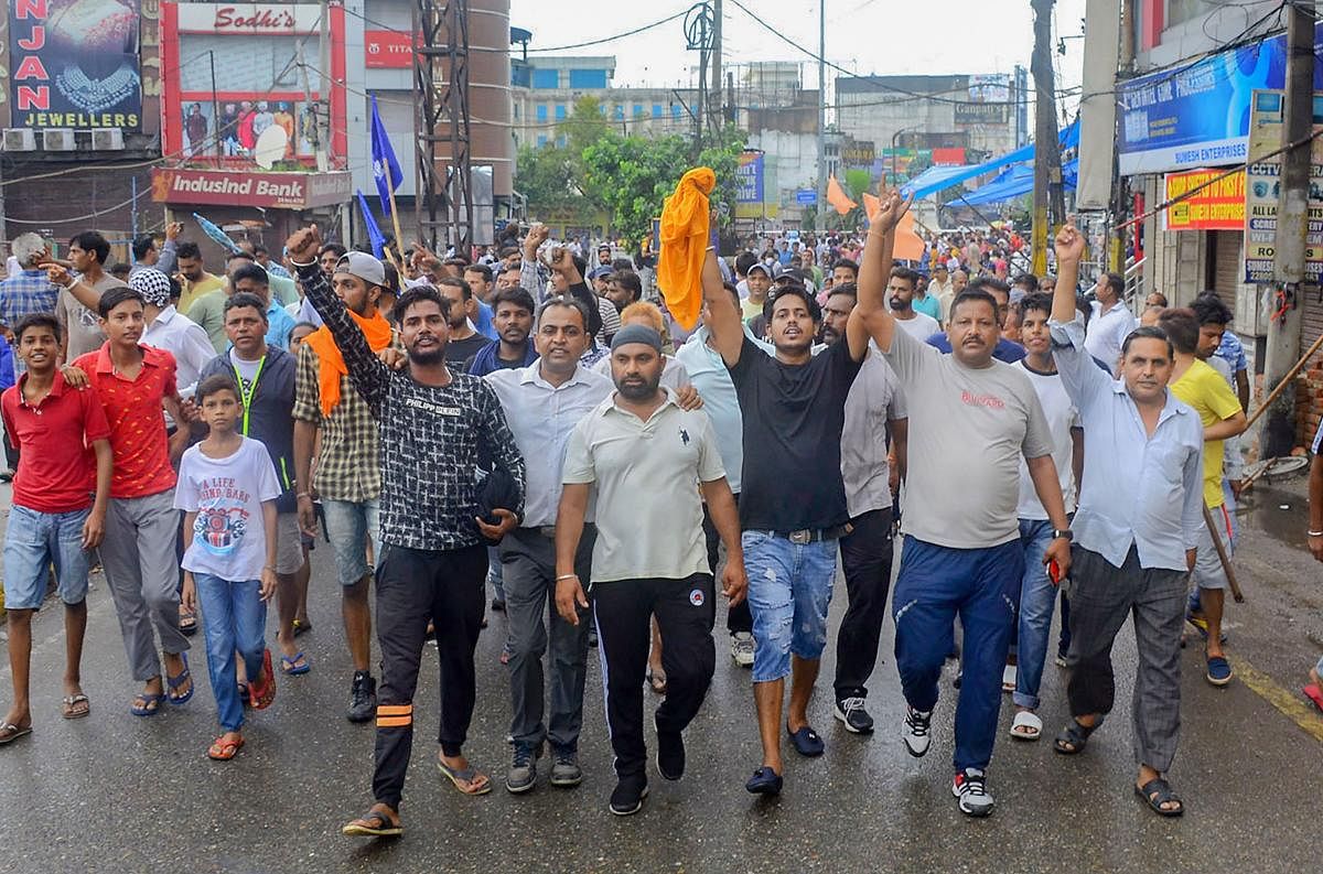 Members of the Dalit community here on Thursday took out a protest march against the demolition of the Guru Ravidas temple in New Delhi. (PTI Photo)