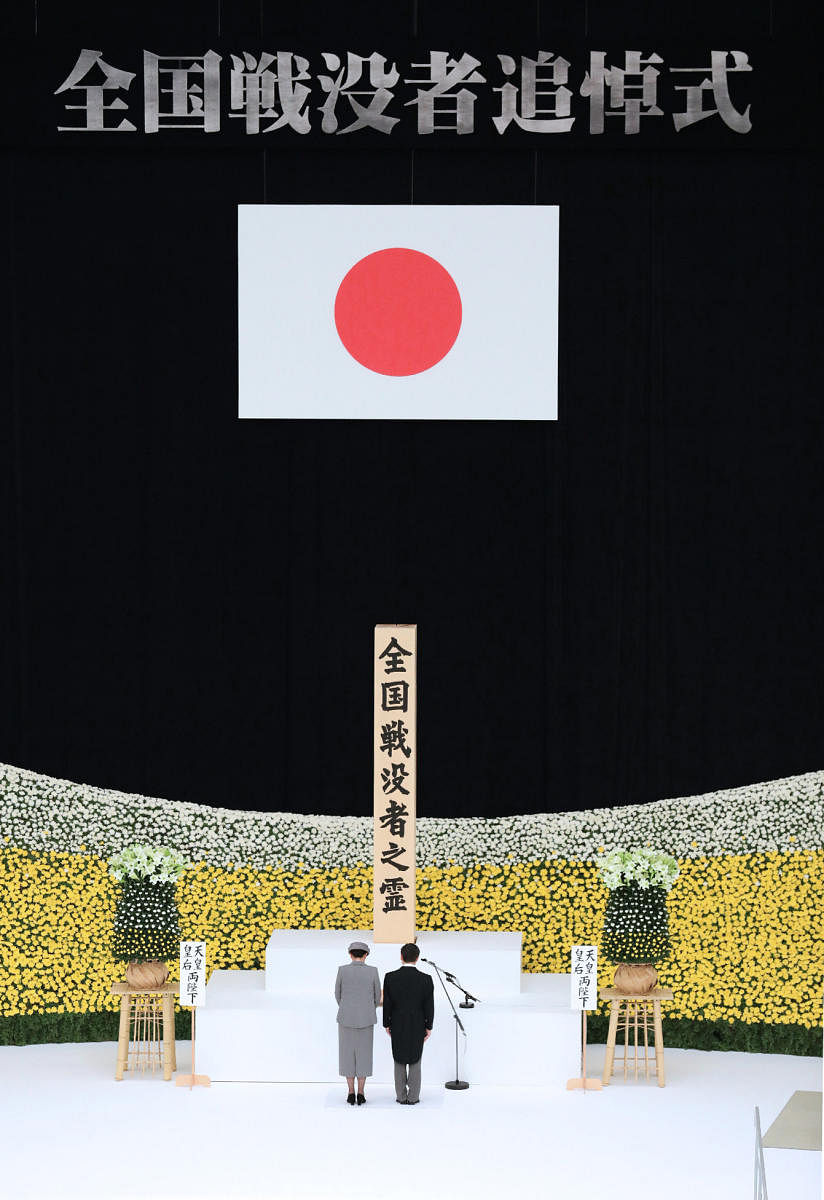 Japan's Emperor Naruhito (R) and Empress Masako (L) offer a silent prayer during an annual memorial ceremony to remember those lost at World War II, in Tokyo on August 15, 2019. (Photo by AFP)