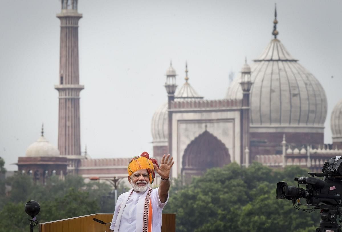 Prime Minister Narendra Modi waves at the crowd from the ramparts of the historic Red Fort on the occasion of 73rd Independence Day. (PTI Photo)