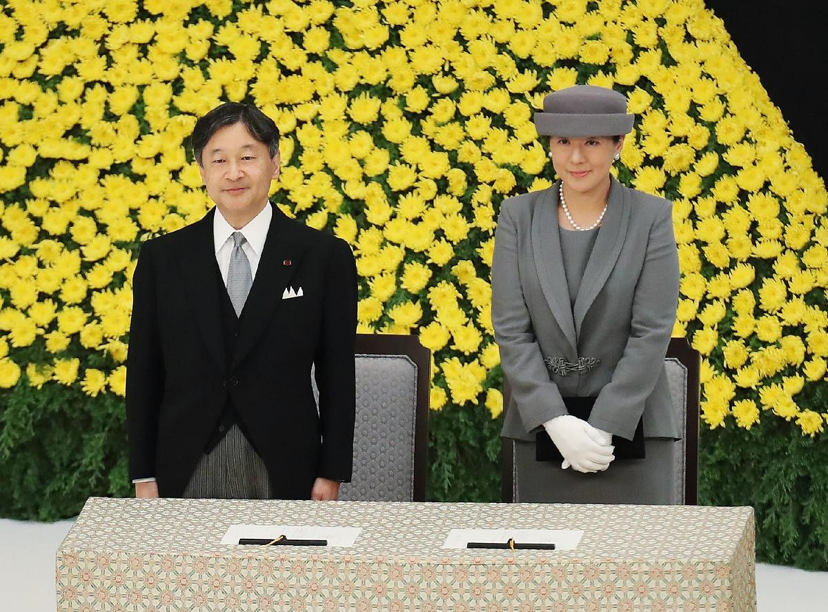 Japan's Emperor Naruhito (L) and Empress Masako (R) attend the annual memorial ceremony to remember those lost at war, on August 15, 2019, in Tokyo as the country marks the 74th anniversary of its surrender in World War II. (Photo by JIJI PRESS / JIJI PRE