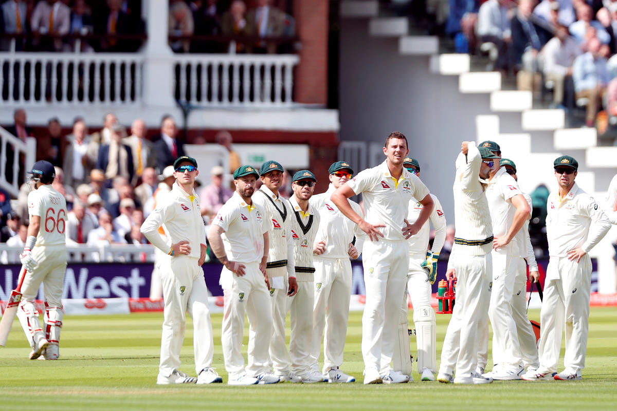 Australia's Josh Hazlewood and teammates watch the replay after taking the wicket of England's Joe Root. (Reuters Photo)