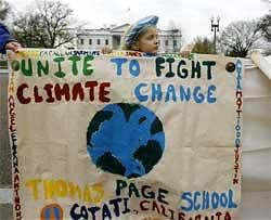 Arundhati Baden-Mayer Eidinger, 5, of Washington holds up banners calling for actions on climate change, Friday, Dec. 4, 2009, in front of the White House in Washington. The UN climate conference that begins Monday in Copenhagen. AP