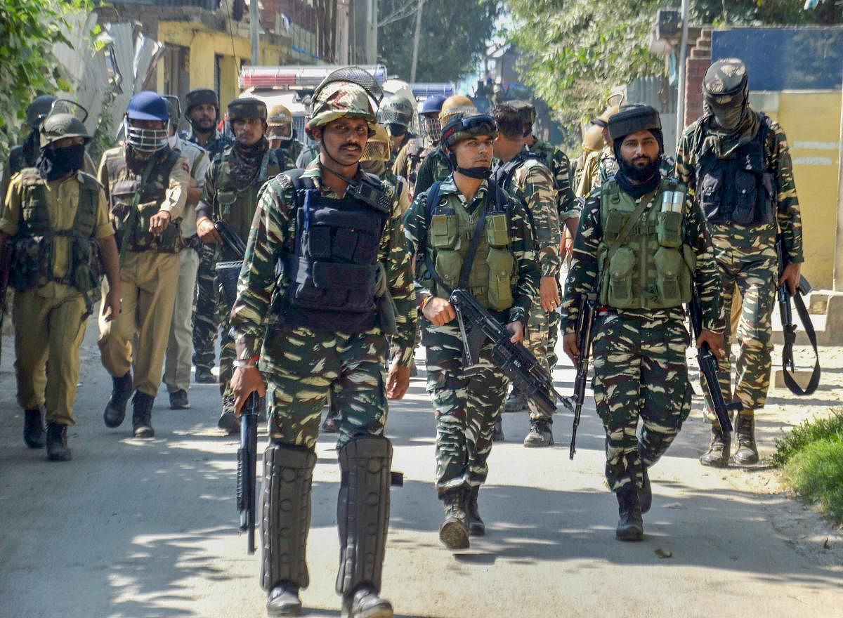 Security forces were deployed outside mosques across Srinagar, while police vans fitted with speakers asked people not to venture out. PTI Photo