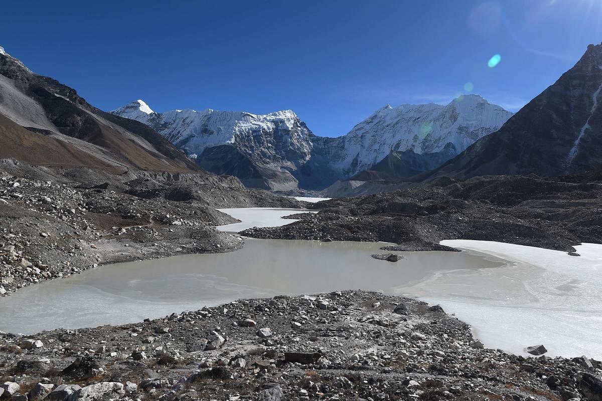 This picture taken on November 22, 2018 shows a general view of the Imja glacial lake controlled exit channel in the Everest region of the Solukhumbu district, some 140km northeast of Kathmandu. - Formed in the shadow of Mount Everest, the turquoise depth