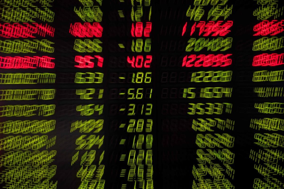 Stock prices are pictured on a screen at a securities company in Beijing on August 15, 2019. (Photo by AFP)