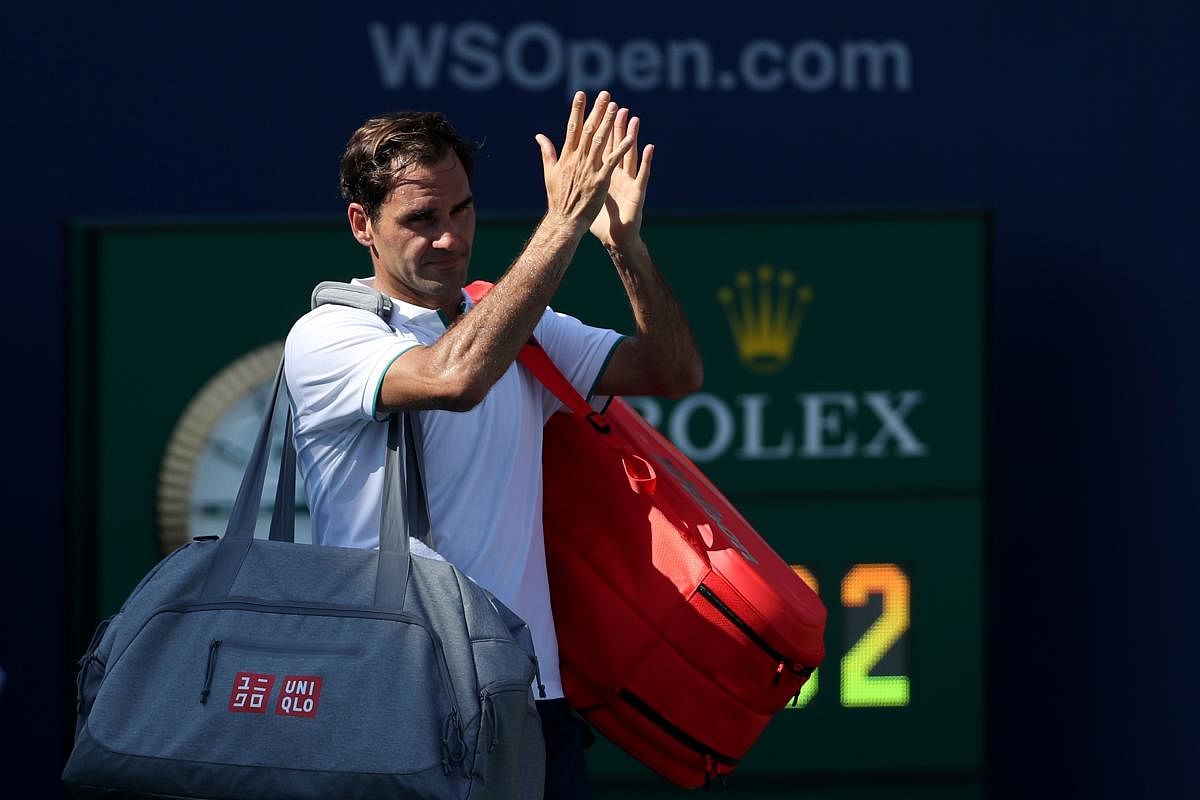 Roger Federer of Switzerland acknowledges the crowd after losing in straight sets to Andrey Rublev of Russia during Day 6 of the Western and Southern Open at Lindner Family Tennis Center. Rob Carr/Getty Images/AFP