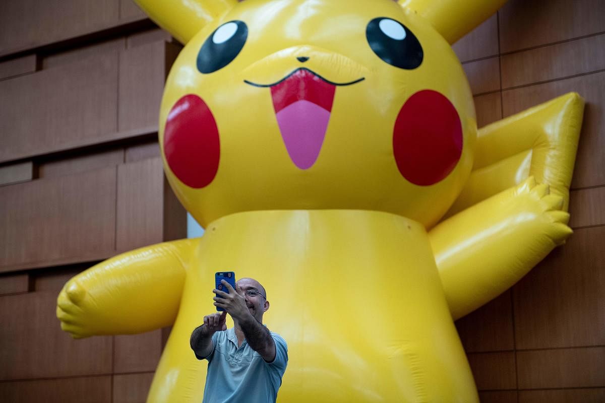 A man takes a selfie with a Pikachu during the first day of the 2019 Pokemon World Championships. (AFP file photo)