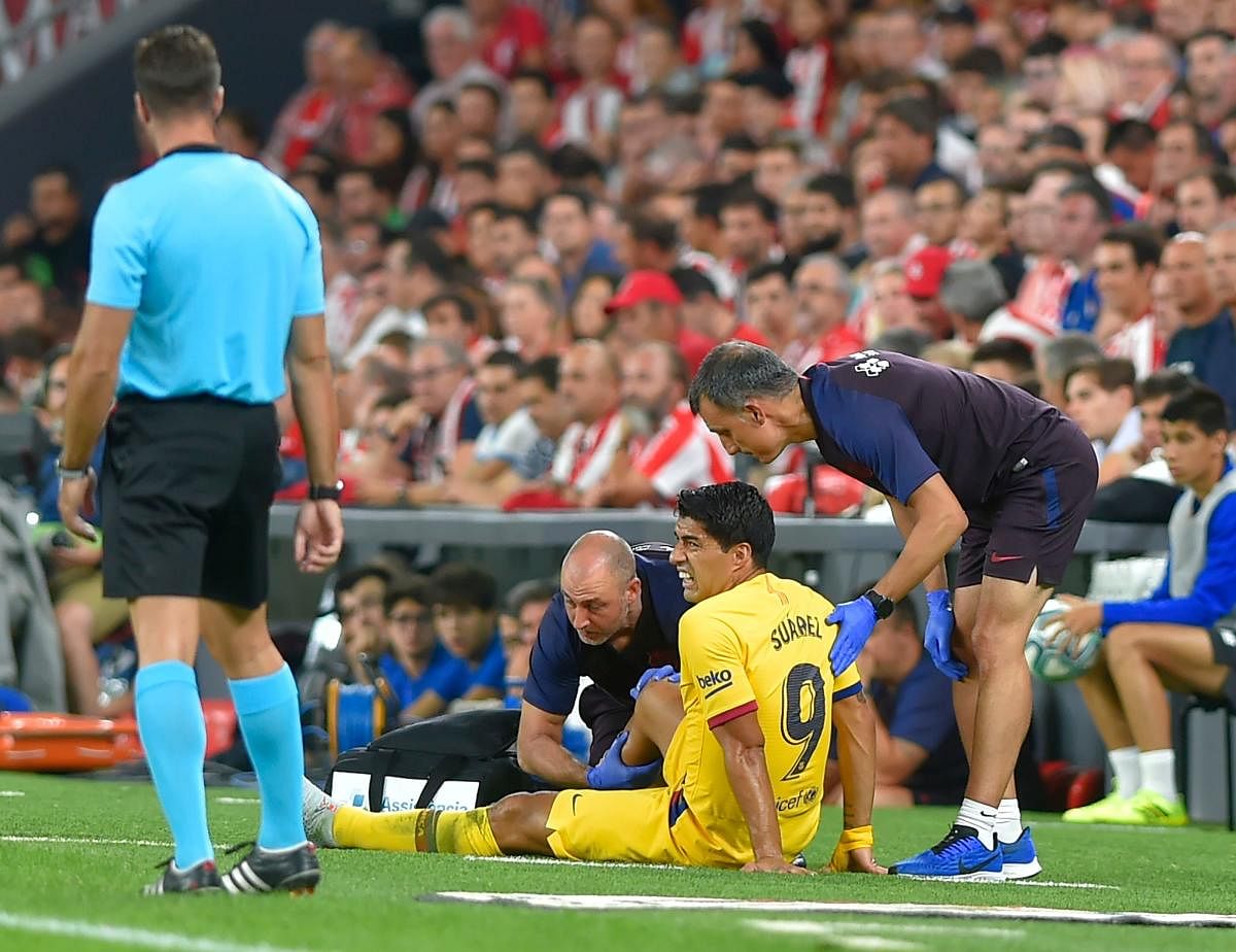 Barcelona striker Luis Suarez suffered a right leg injury during his side's defeat at Athletic Bilbao in Friday's La Liga opener (AFP Photo)