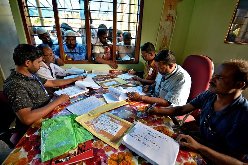  People wait to check their names on the draft list at the National Register of Citizens (NRC) centre at a village in Nagaon district, Assam. (Reuters Photo)