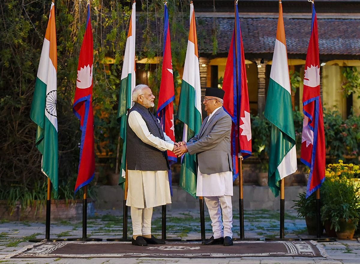 Prime Minister Narendra Modi shakes hands with his Nepali counterpart KP Sharma Oli ahead of delegation level talks in Kathmandu on Friday. (PTI Photo / PIB)
