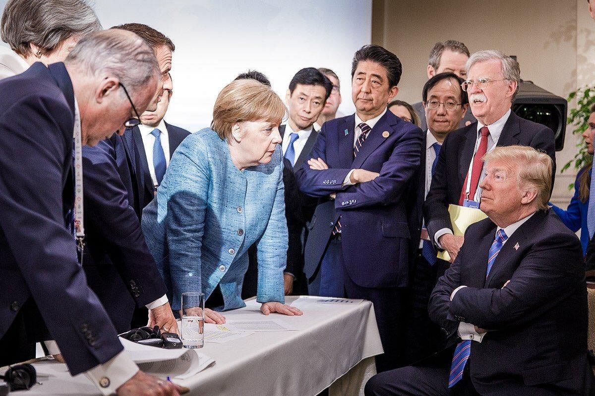 US President Donald Trump talks with German Chancellor Angela Merkel surrounded by other leaders during the G7 Summit in La Malbaie, Quebec, Canada. (AFP File Photo)