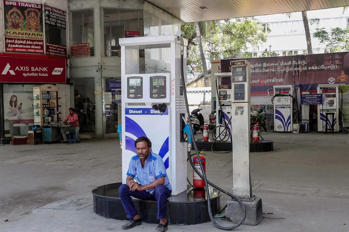 A security person guards a petrol pump in Coimbatore. PTI