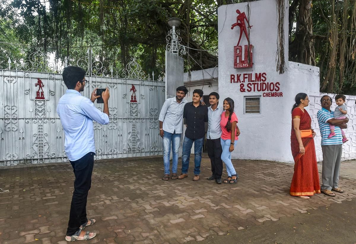 People click photographs outside the iconic RK Studio, at Chembur in Mumbai on Sept 14, 2018. (PTI File Photo)