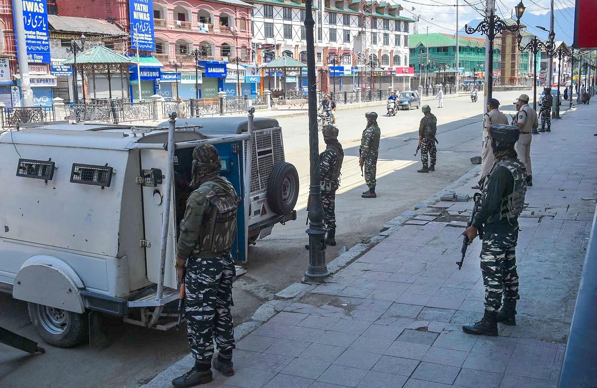 CRPF personnel stand guard at Lal Chowk after restrictions were lifted, in Srinagar. (PTI Photo)