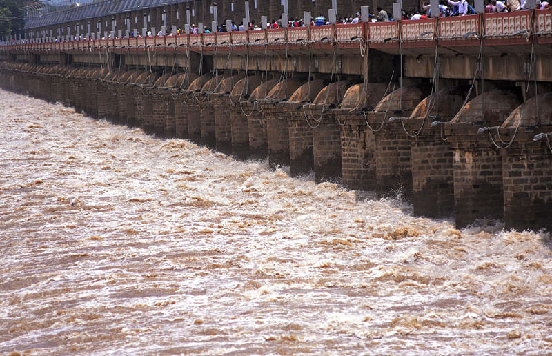 Water gushes out as all the gates of Prakasam Barrage across the Krishna river have been opened due to heavy inflow following monsoon rains, in Vijayawada. (PTI Photo)