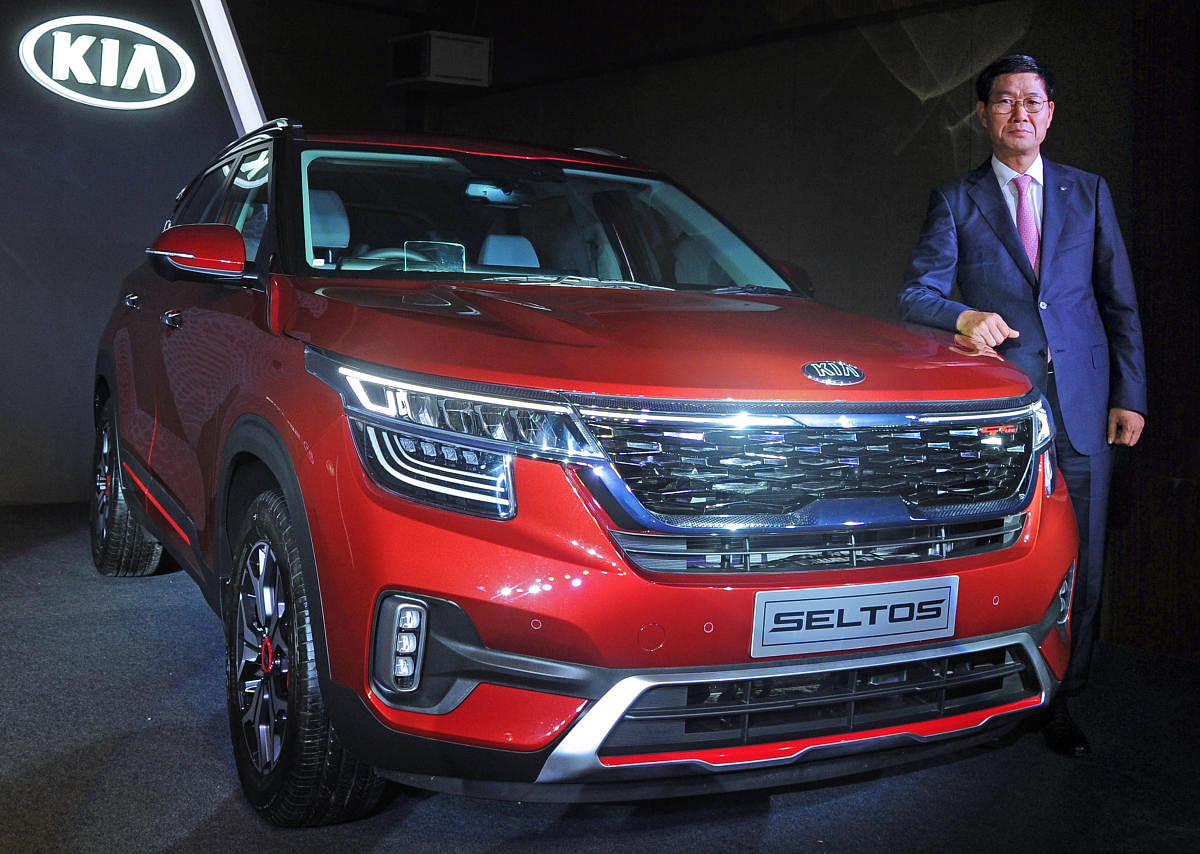 KIA Motors India CEO and managing director Kookhyun Shim poses with the Seltos SUV during the car’s launch in Bengaluru on Friday. DH photo