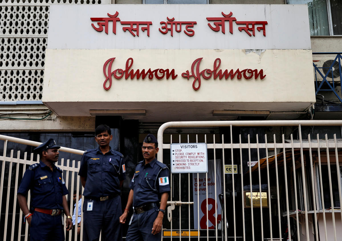 Security guards stand outside the office of Johnson &amp; Johnson in Mumbai, India. (Reuters Photo)