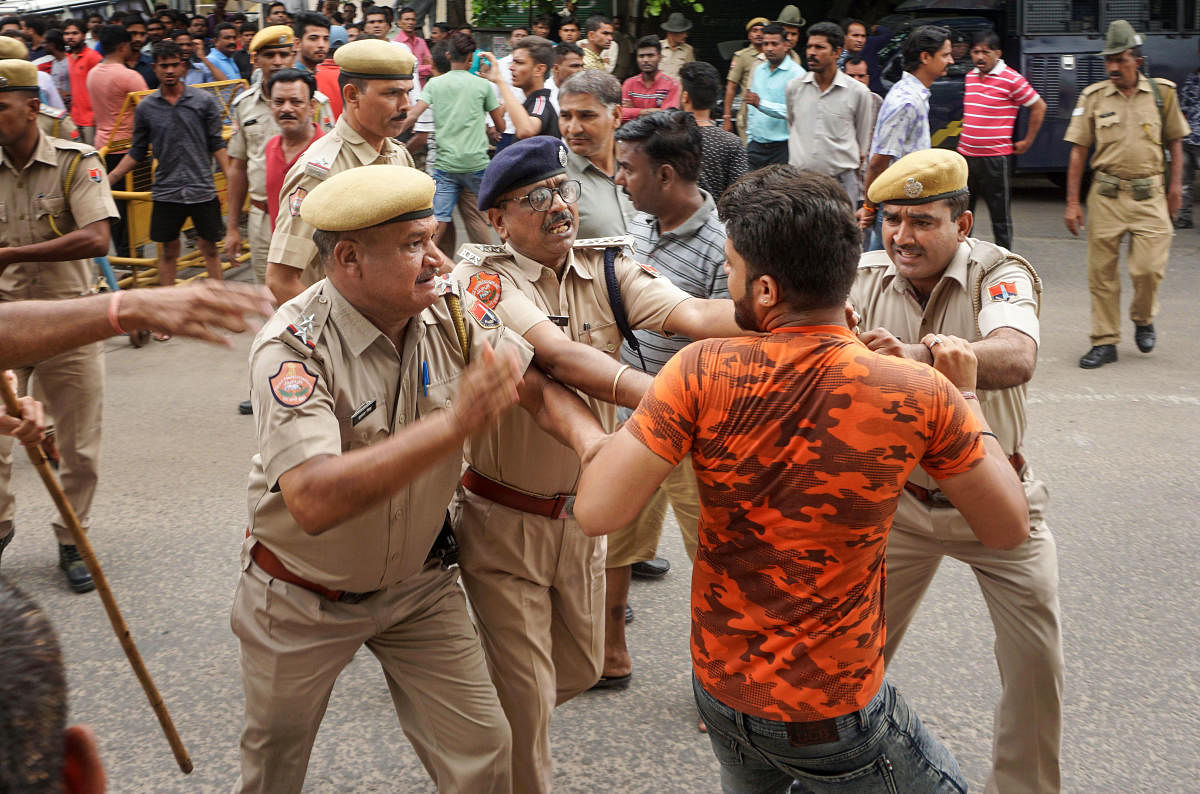 Police take action against protesters during an agitation over the rape of a minor, in Shastri Nagar area of Jaipur. (PTI Photo)