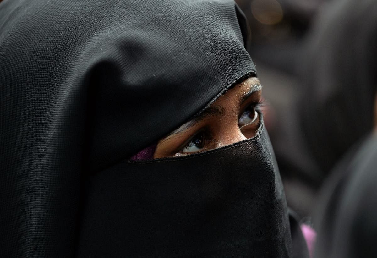 India's parliament passed on July 30 a law against the controversial Muslim practice of "instant divorce", making it a criminal offence punishable by up to three years in prison. (Photo by AFP)