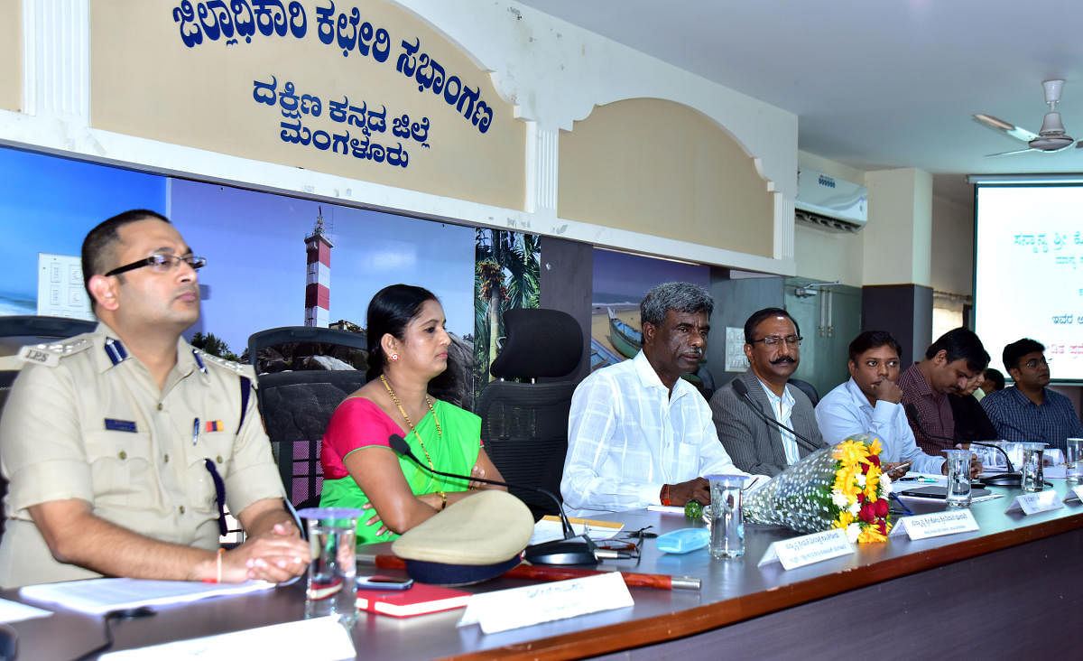 Minister Kota Srinivas Poojary conducts a review meeting at the DC's office in Mangaluru on Thursday.