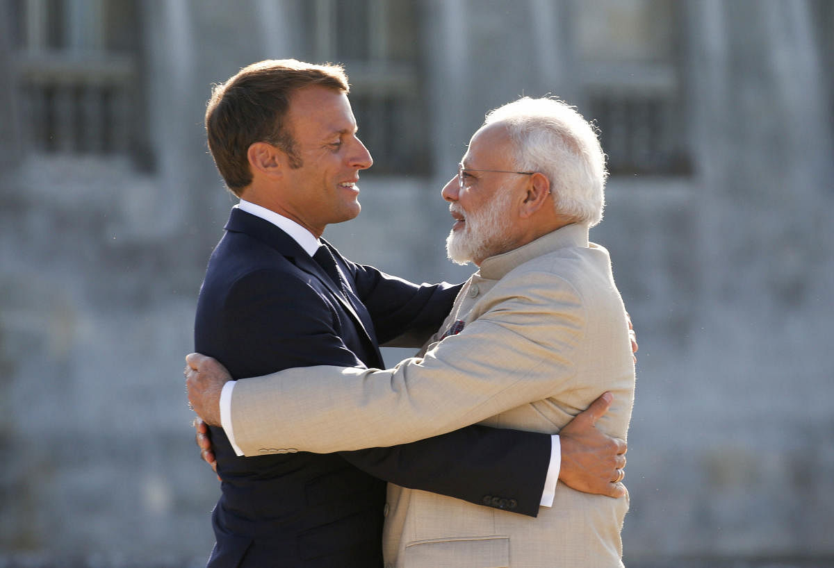 Chantilly: French President Emmanuel Macro, left, welcomes Indian Prime Minister Narendra Modi before a meeting at the Chateau of Chantilly. (PTI Photo)