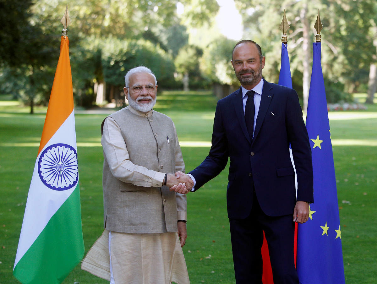 Prime Minister Narendra Modi shakes hands with French Prime Minister Edouard Philippe in the garden of the Prime Minister's residence before their talks in Paris, France. Reuters photo