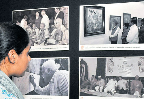 A visitor admires the photographs at an exhibition to commemorate the birth anniversary of former chief minister Devaraj Urs at the Chitrakala Parishath on Thursday. DH photo