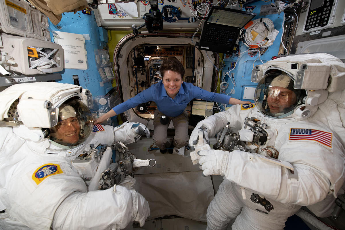 A file photo of astronaut Anne McClain (centre) on the International Space Station as she assists fellow astronauts Christina Koch and Nick Hague before a spacewalk. Credit: Reuters