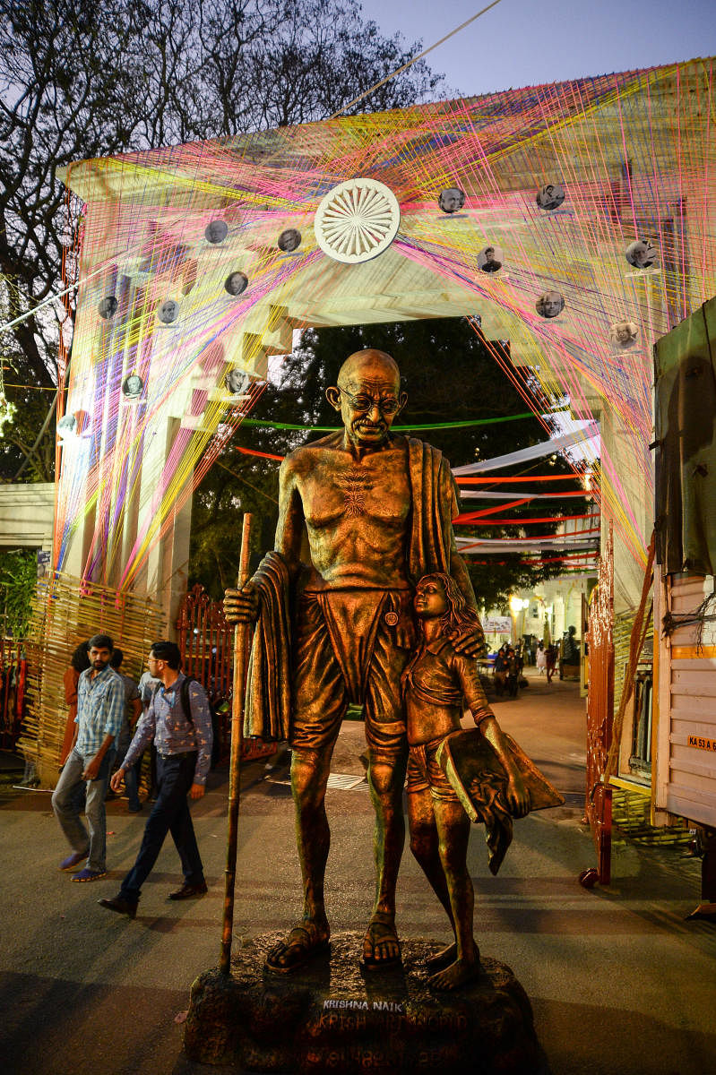 A statue of Mahatma Gandhi at the entrance of the Karnataka Chitrakala Parishath on Saturday. (DH Photo/Satish Badiger)