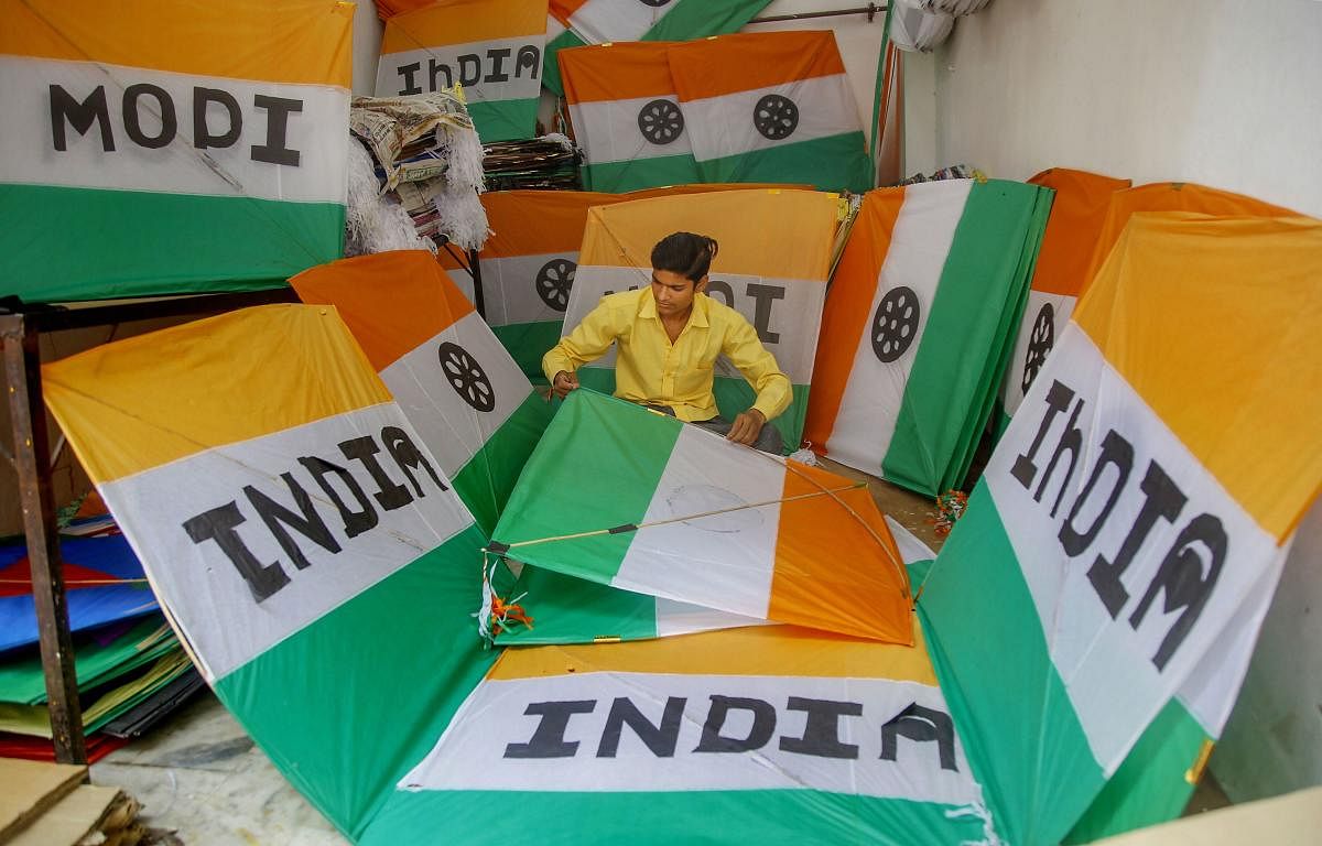 A kitemaker makes 'tricoloured' kites ahead of Independence Day, at a shop in Jammu  (PTI Photo)