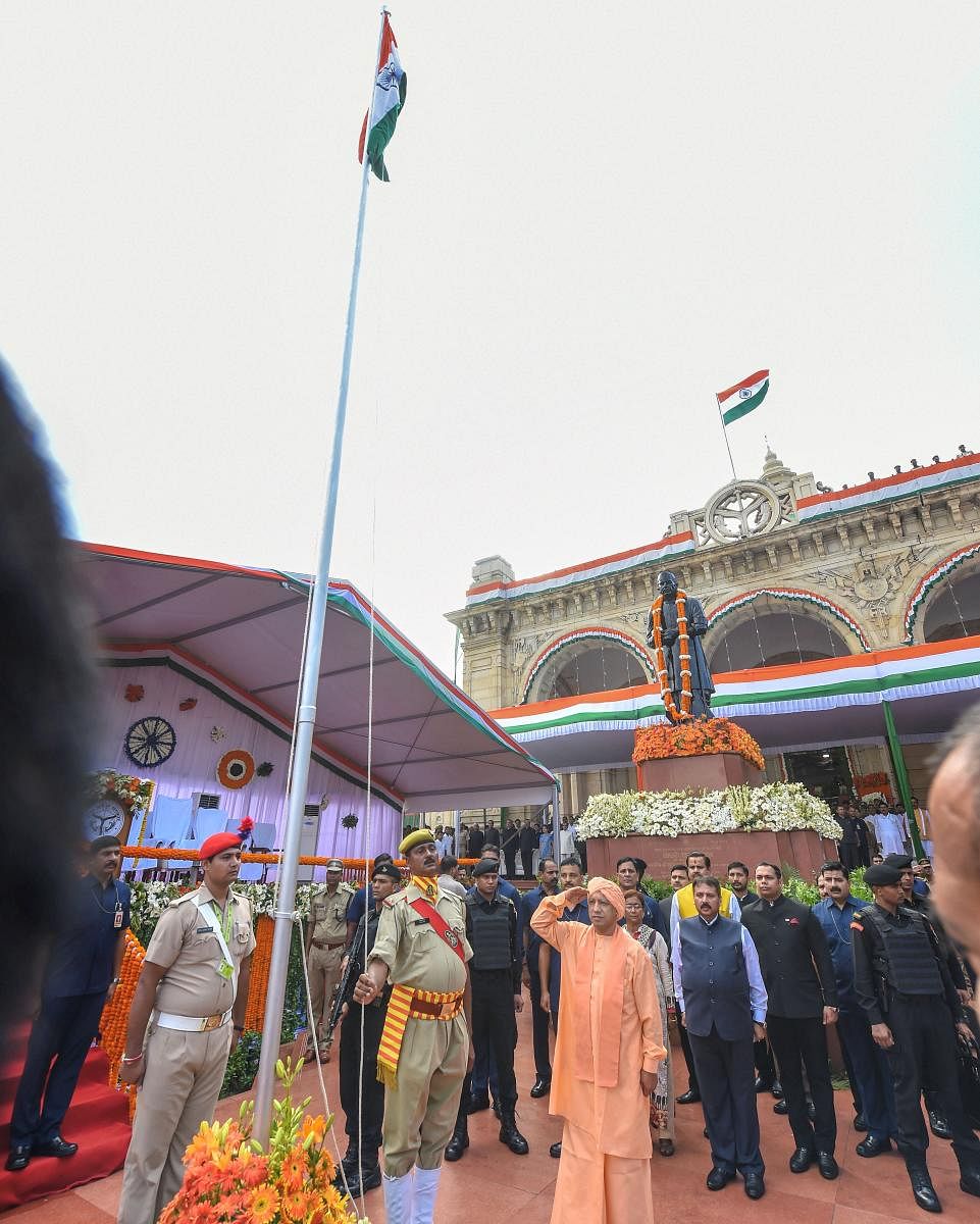 Uttar Pradesh Chief Minister Yogi Adityanath salutes the National Flag hoisting during the 73rd Independence Day celebrations, at Vidhan Sabha in Lucknow. PTI Photo