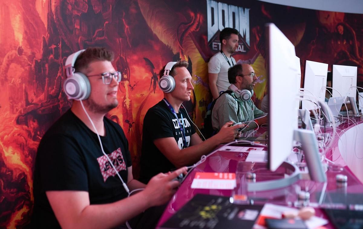 Visitors play the cloud-game based "Doom" at the stand of Google Stadia during the Video games trade fair Gamescom in Cologne, western Germany. (AFP Photo)
