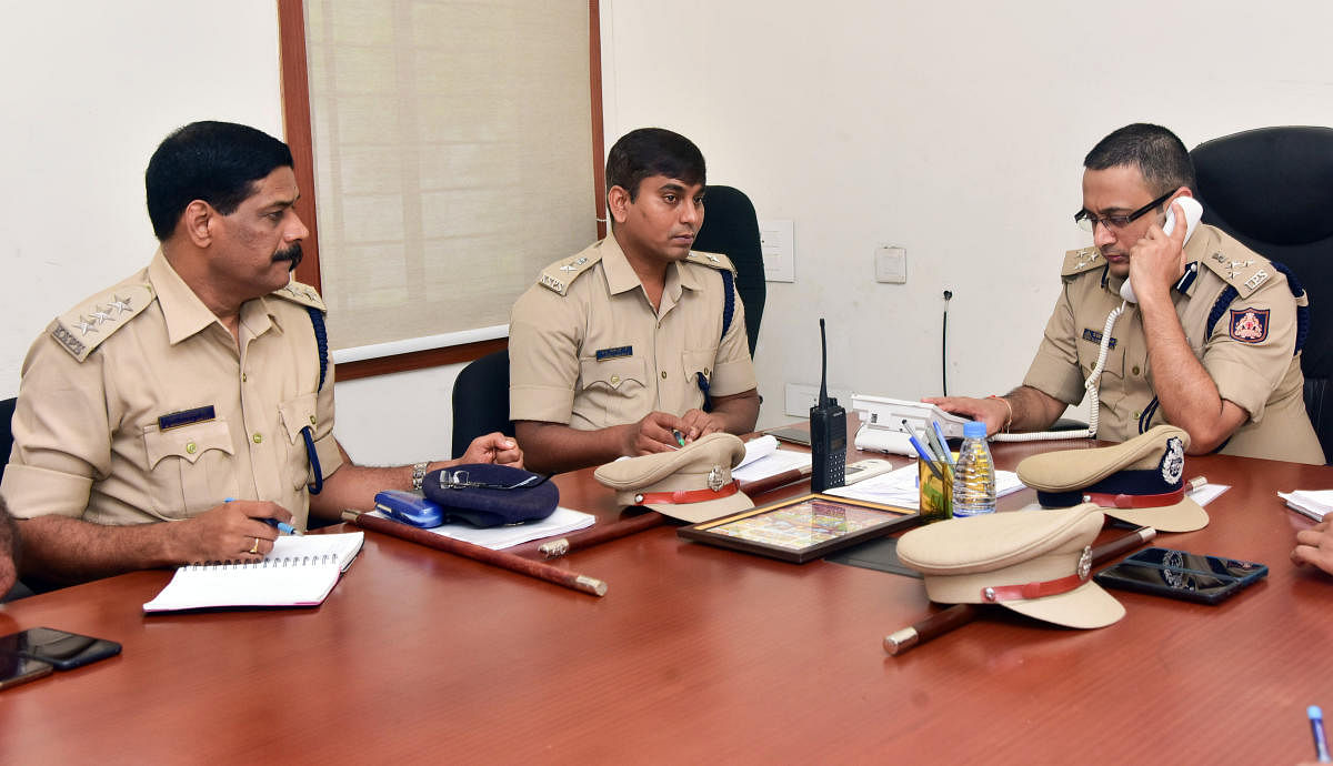 Commissioner of Police Dr P S Harsha receives a call during the weekly phone-in programme in Mangaluru on Friday.