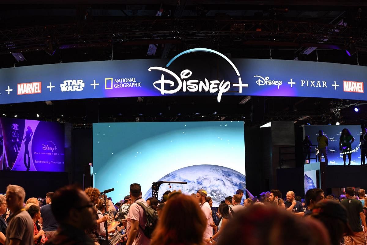 Attendees visit the Disney+ streaming service booth at the D23 Expo, billed as the "largest Disney fan event in the world," August 23, 2019 at the Anaheim Convention Center in Anaheim, California. - Disney Plus will launch on November 12 and will compete