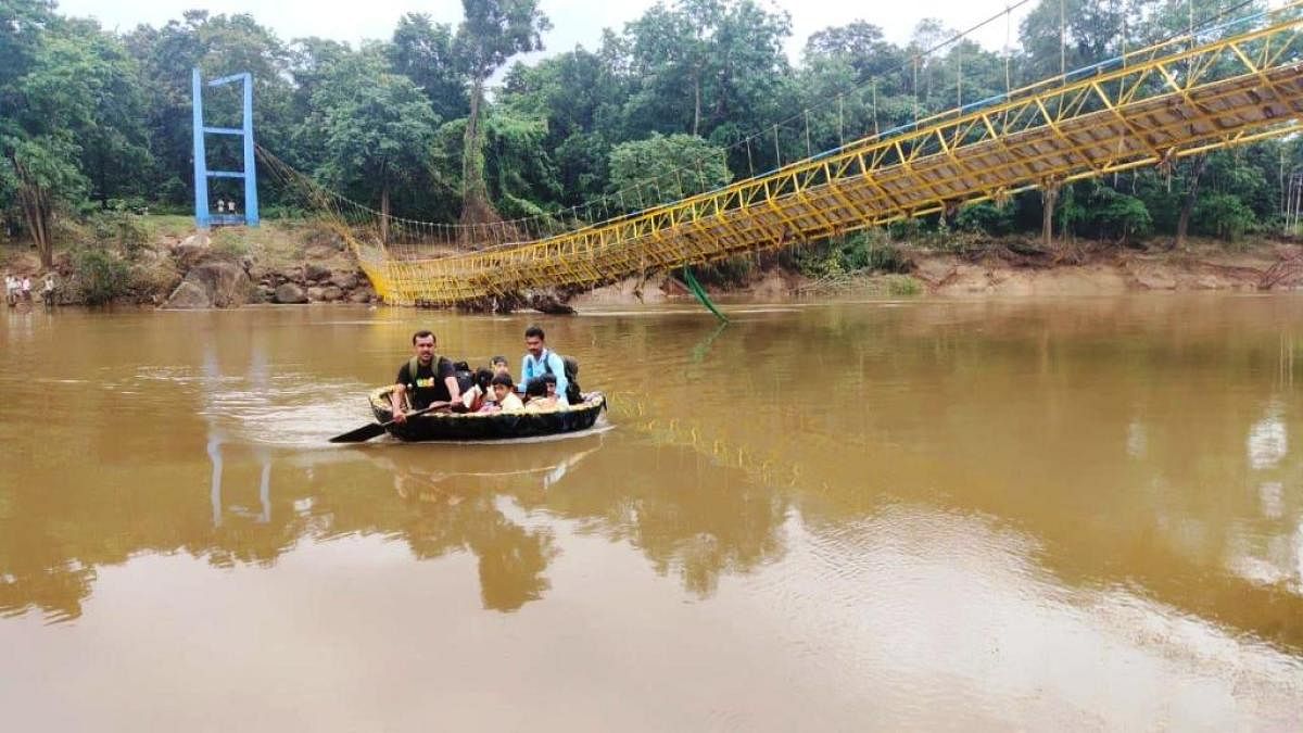 School children cross River Bhadra using a coracle near Balehonnur.