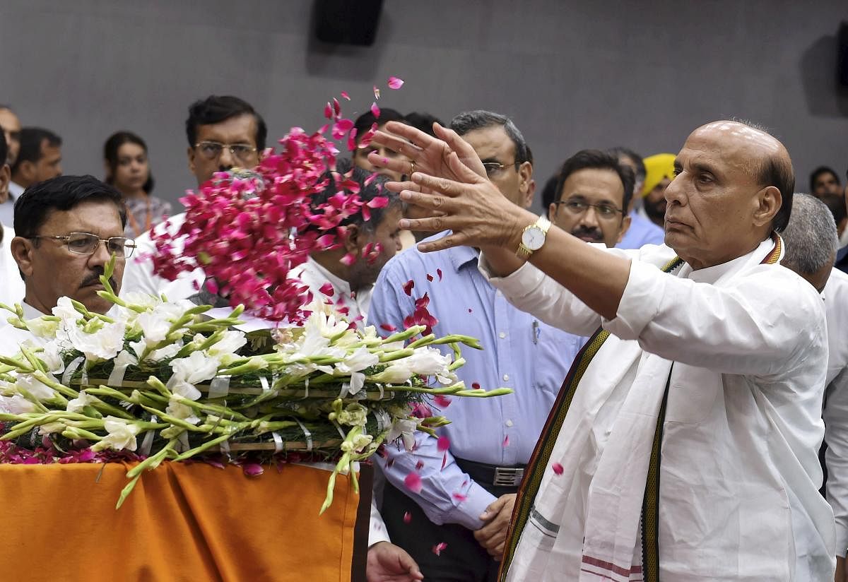 Defence Minister Rajnath Singh pays his last respects to the mortal remains of BJP leader and former finance minister Arun Jaitley at BJP HQ, in New Delhi on Sunday. PTI file photo