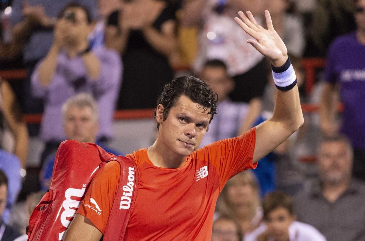 Milos Raonic waves to the crowd as he walks off the court after withdrawing from his match against countryman Felix Auger-Aliassime during the Rogers Cup men tournament. AP/PTI
