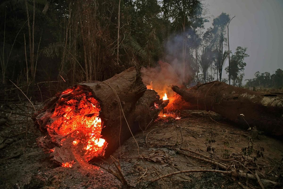 President Jair Bolsonaro authorized Friday the deployment of Brazil's armed forces to help combat fires raging in the Amazon rainforest. (Photo by AFP)