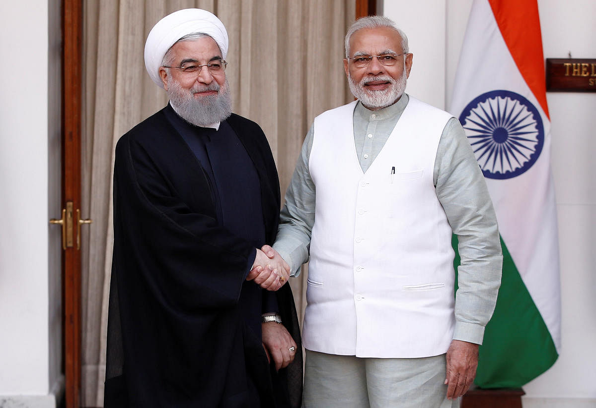 File Reuters photo of Iranian President Hassan Rouhani shakes hands with India's Prime Minister Narendra Modi 