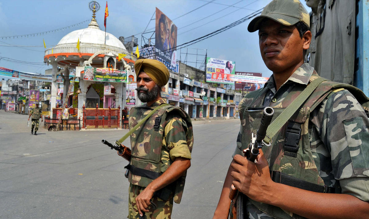 Soldiers stand guard on a deserted street during a curfew in Muzaffarnagar in 2013./REUTERS