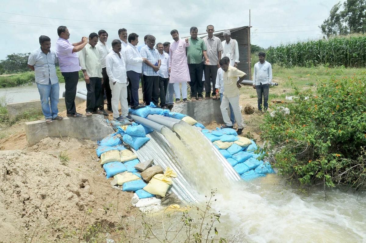 Minister C T Ravi inspects the pump installed at Devikere to draw water to Karagada canal.