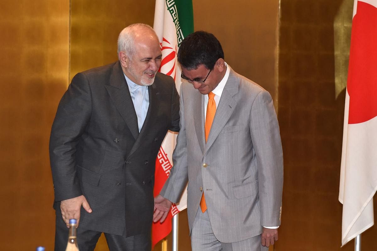 Iran's Foreign Minister Mohammad Javad Zarif (L) chats to his Japanese counterpart Taro Kono (R) before the start of their talks at a hotel in Yokohama (AFP Photo)