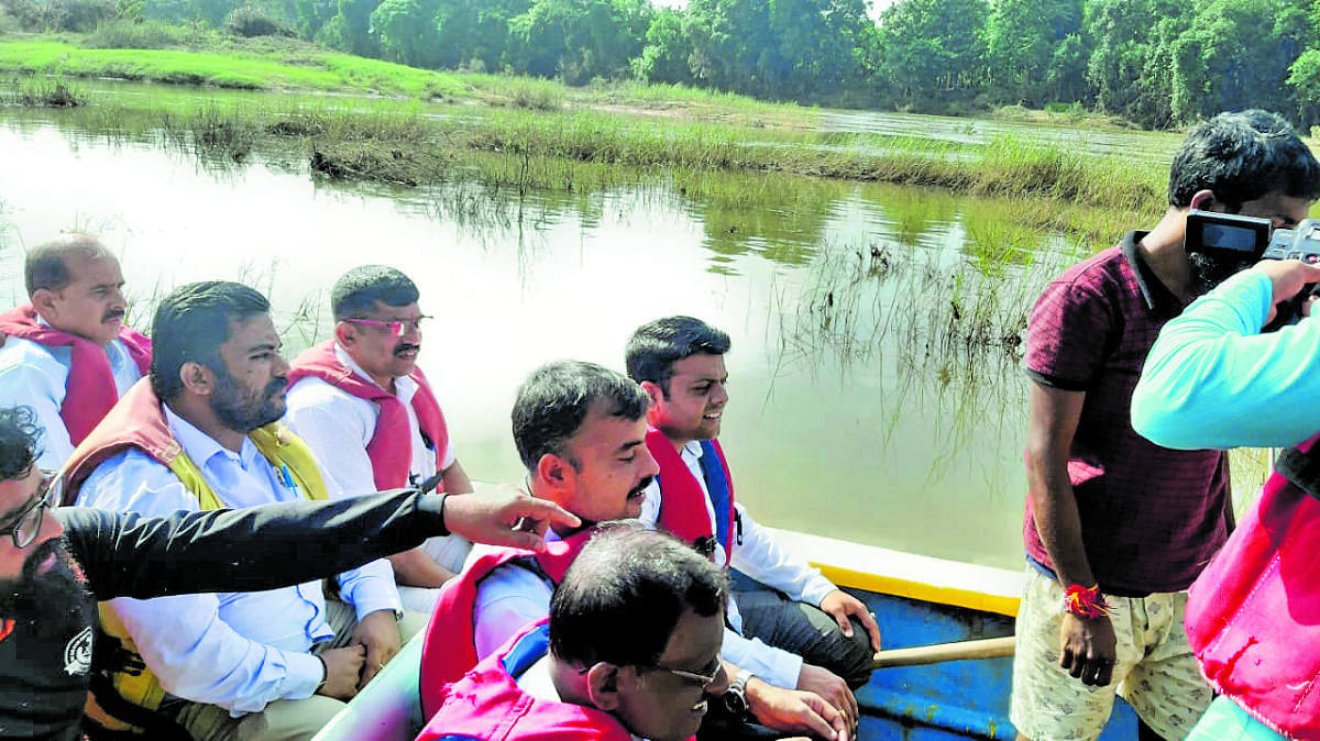 Belthangady MLA Harish Poonja, Tahsildar Ganapathi Shastri and others travel in a boat between Valalu in Puttur taluk and Mugeradka in Belthangady taluk.