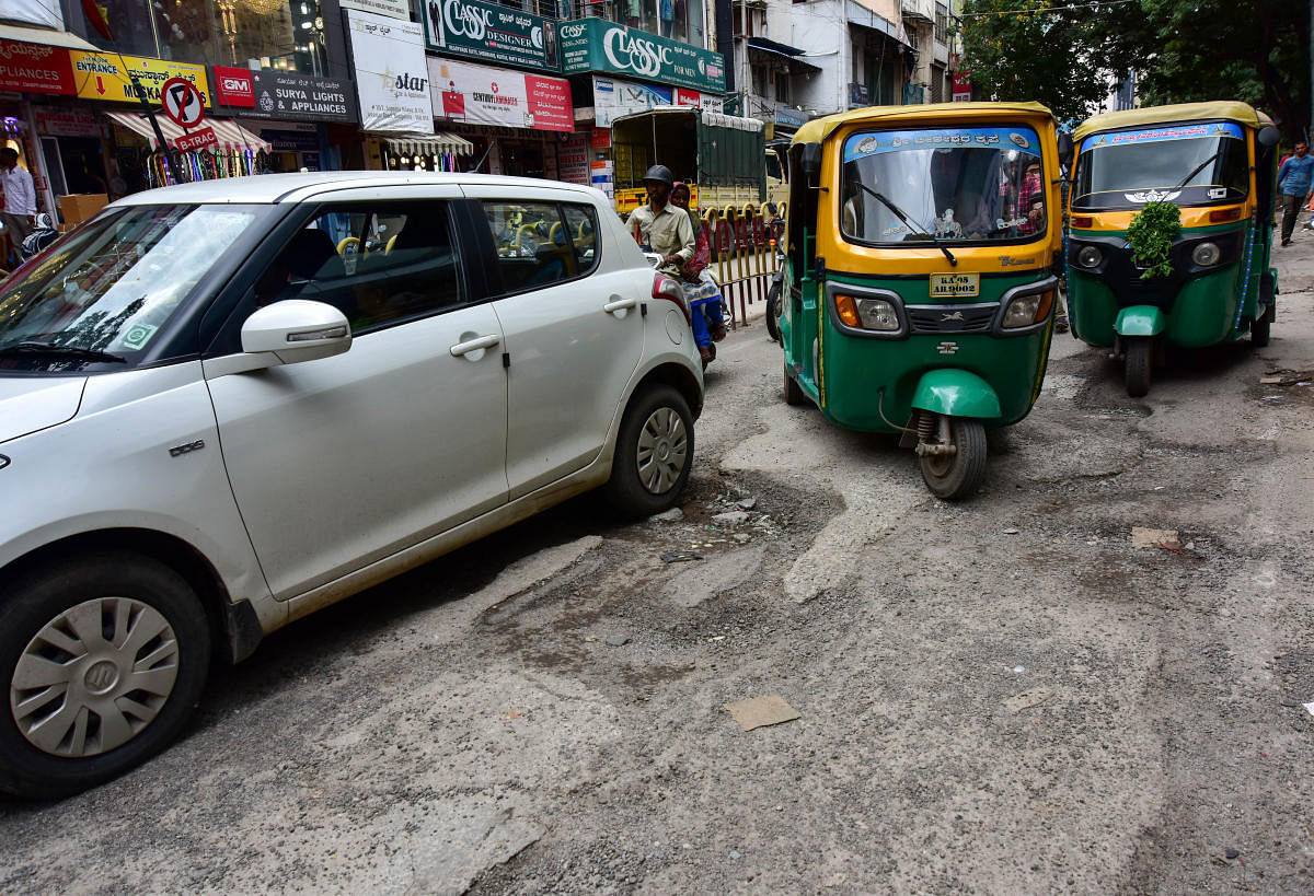 The BBMP has earmarked Rs 12 crore for filing up potholes on major roads. The picture shows a pothole-filled BVK Iyengar Road in Chickpet. DH PHOTO/IRSHAD MAHAMMADA