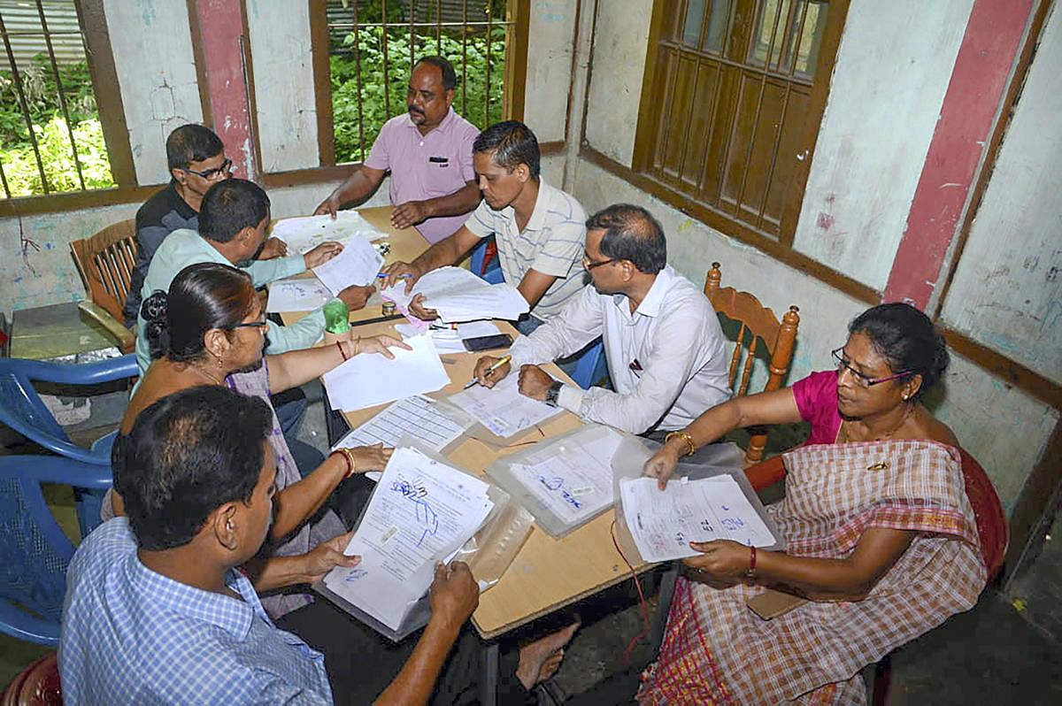 Officials check the documents submitted by people, ahead of the release of the final draft of National Register of Citizens (NRC), at an NRC Seva Kendra in Guwahati. PTI file photo