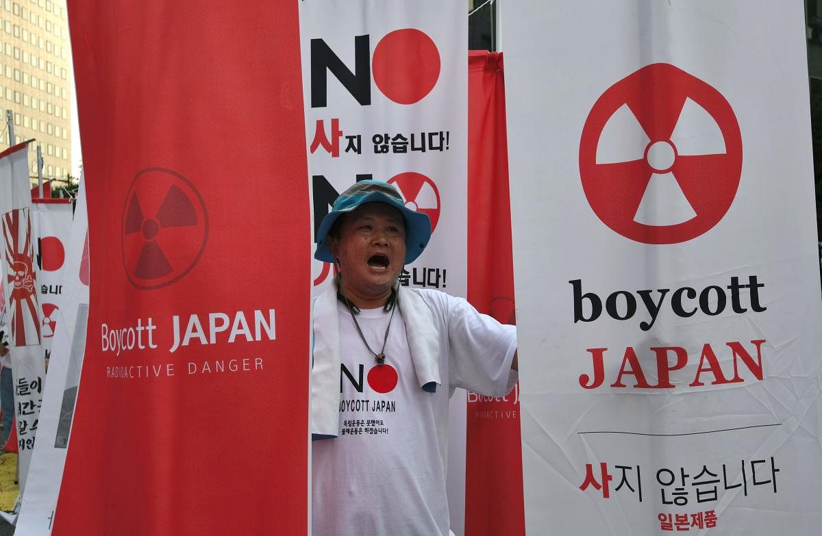 A protester holding anti-Japanese banners during a rally against Japan's decision to remove South Korea from a so-called "white list" of favoured export partners, near the Japanese embassy in Seoul. Photo/AFP