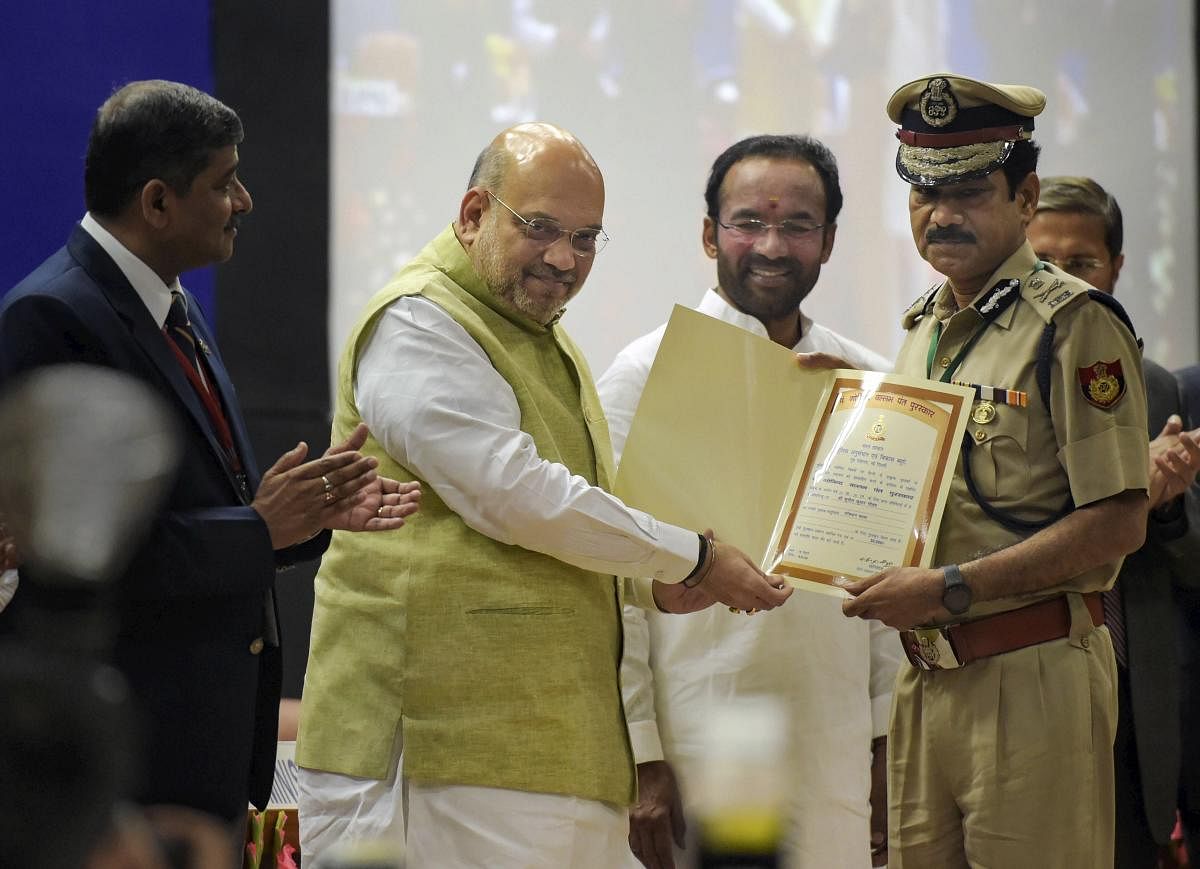 Home Minister Amit Shah presents an award to DCP Sunil Kumar Gautam during the 49th Foundation Day celebrations of BPR&amp;D, at its headquarters, in New Delhi. PTI photo