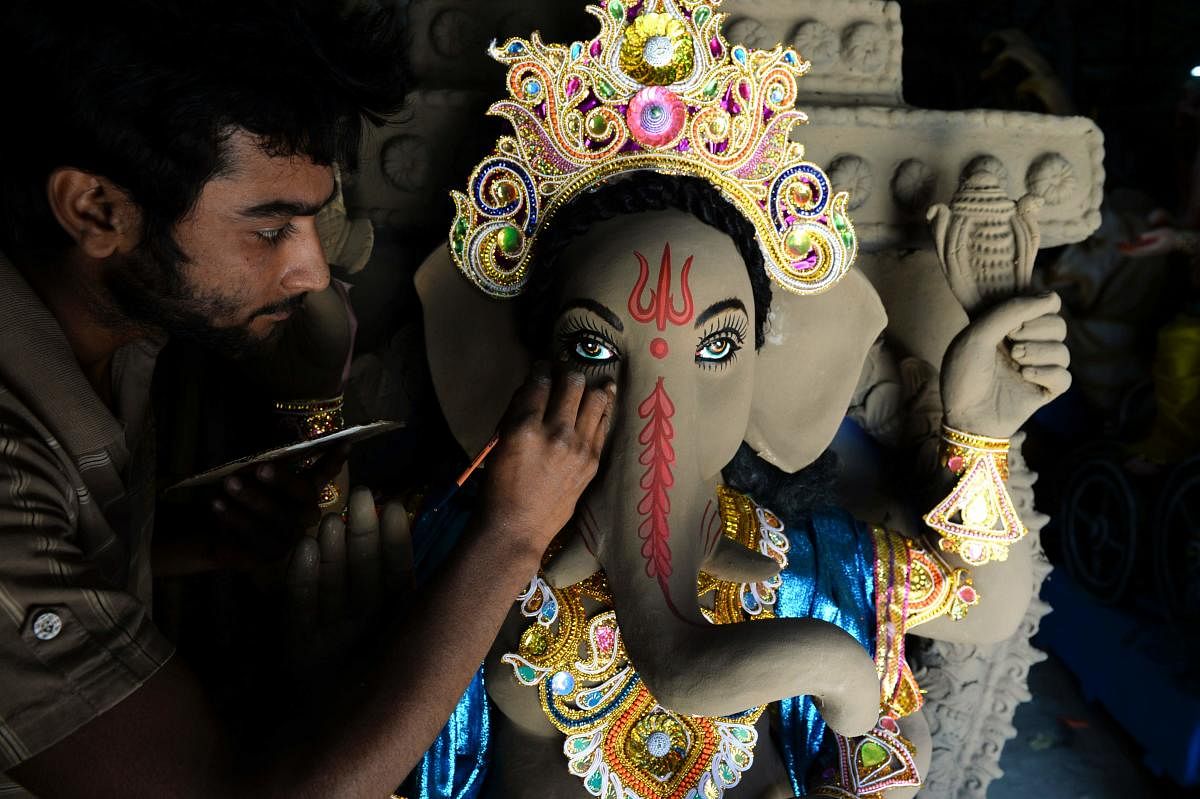 An Indian artisan works on a sculpture of Hindu Lord Ganesh ahead of the upcoming "Ganesh Chaturthi" Hindu festival, at a workshop in Hyderabad. (AFP Photo)