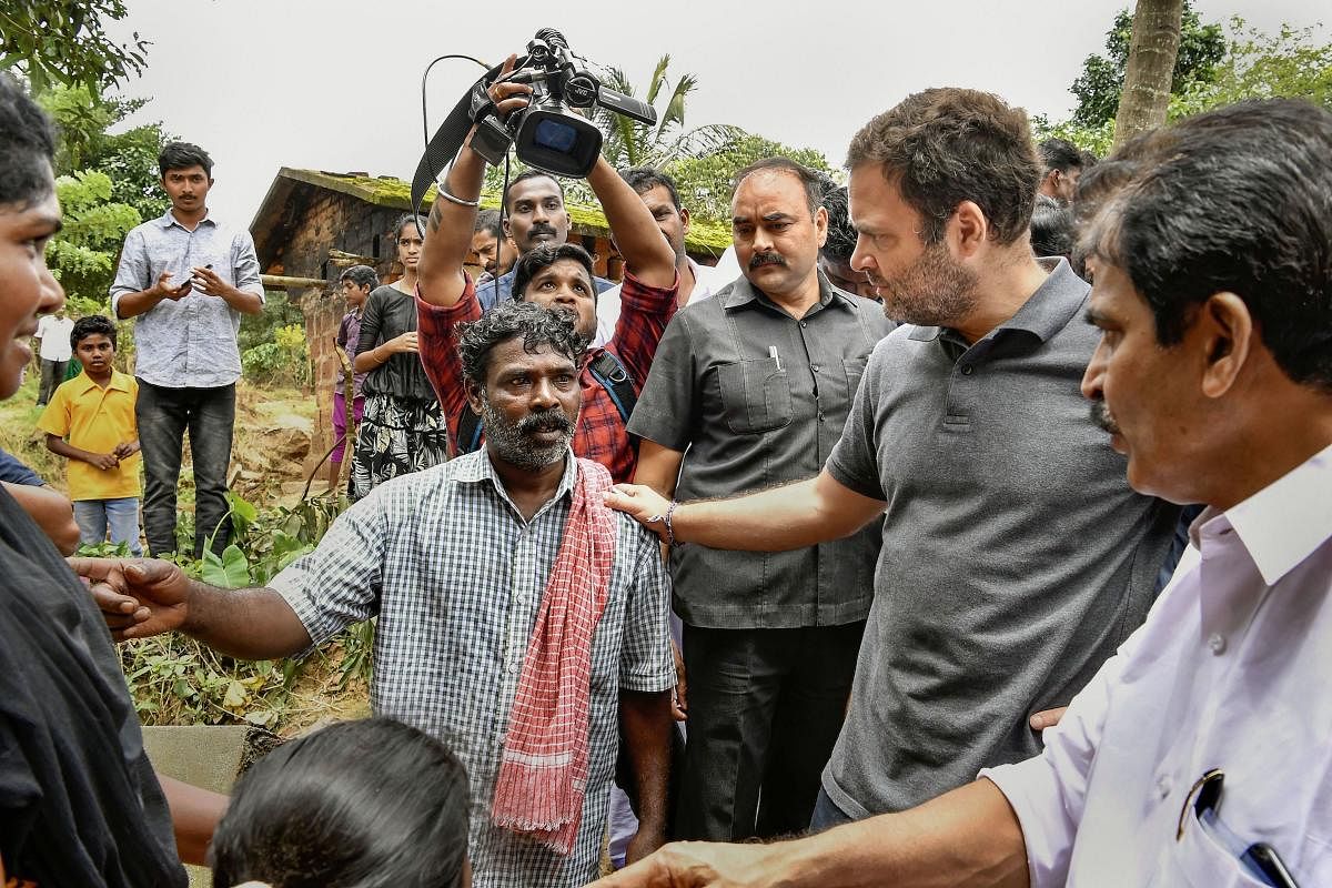 Former Congress president and Wayanad MP Rahul Gandhi interacts with flood victim families at a relief camp at Chaligandha, Payyampally village in Wayanad on Wednesday. PTI photo